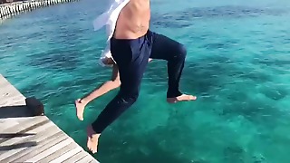 Me and my enjoy are leaping in the blue river at the paradise